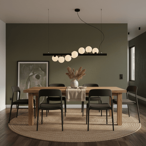 Modern dining room featuring a Spiral 7 Light Black Pendant Light above a wooden table with black chairs.