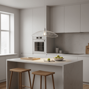 Sensu Solo White Pendant Light hanging over a modern kitchen island with wooden stools and a bowl of green apples.