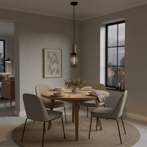 Midnight Long Mesh & Stone Pendant Light hanging over a wooden dining table set with dishes and flowers.