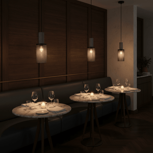 Stylish pendant lights illuminate elegant dining tables in a modern restaurant setting.
