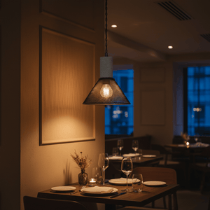 Midnight Cone Mesh & Stone Pendant Light illuminating a dining table in a cozy restaurant setting.