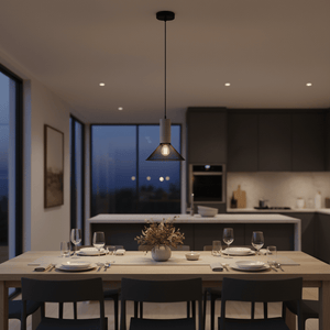 Midnight Cone Mesh & Stone Pendant Light hanging above a dining table set for dinner, creating a warm ambiance.