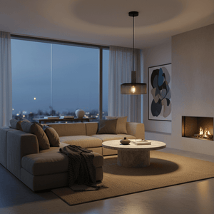 Industrial-style pendant light hanging over a modern lounge area with a cozy sofa and coffee table.