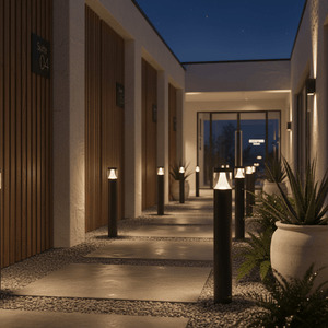 Cedarville LED bollard lights illuminating a pathway with modern design and warm white light.