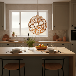 Alberta Geo Copper Pendant Light hanging above a dining table set with plates and a fruit bowl in a modern kitchen.