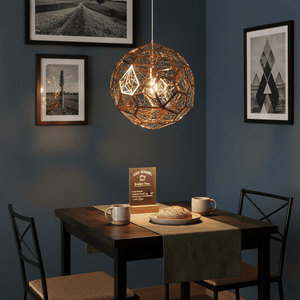 Alberta Geo Copper Pendant Light hanging over a dining table with coffee mugs and bread.