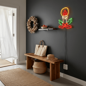 LED Christmas lights in candle motif illuminating a cozy entryway with a wooden bench and decorative wreath.