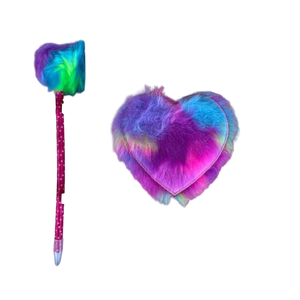 Pink polka‑dot pen with multicolored fluffy top beside a rainbow‑hued fluffy heart shape