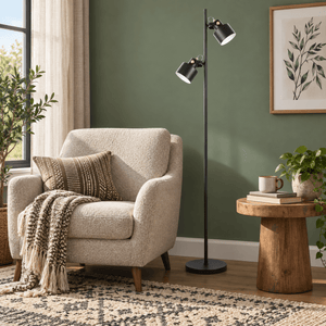 Orka black floor lamp beside a sage reading chair
