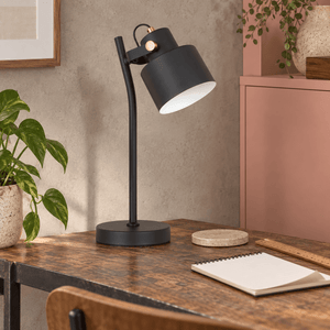 Orka black table lamp on a clay pink workspace desk