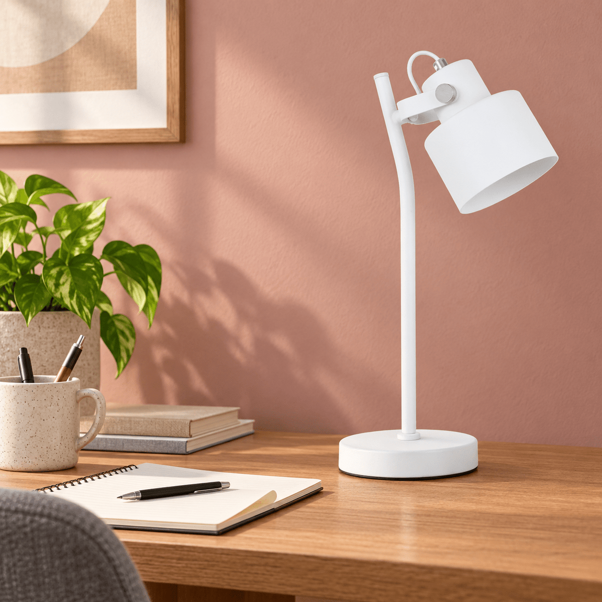 Orka white table lamp on a clay pink home office desk