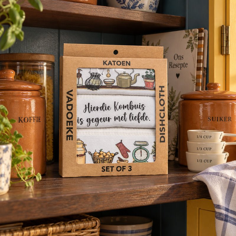 KATOEN Dishcloth Box with printed tea towels on a pantry shelf