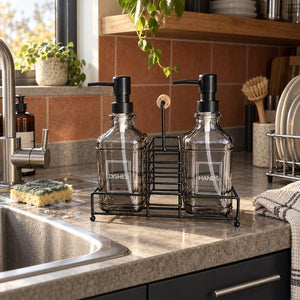 Smoked grey glass soap dispenser set beside a scullery basin