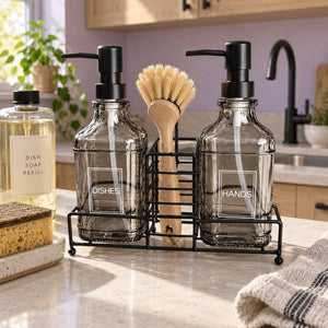Smoked grey glass soap dispenser set with refill bottle on a kitchen counter