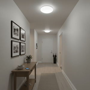 A well-lit hallway featuring a flush ceiling light, a wooden console table with decor, and framed photos on the wall.