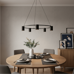 Stylish black 5-light round pendant hanging above a wooden dining table set with plates and decor.
