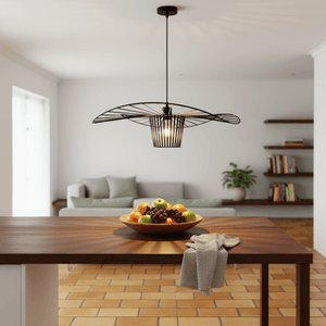 Sensu Infinite Black Pendant Light hanging above a wooden table with a fruit bowl, showcasing its modern design.