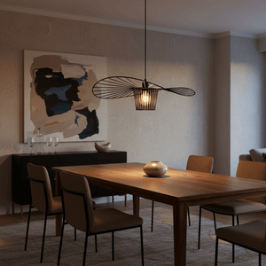 Sensu Infinite Black Pendant Light hanging above a wooden dining table with modern chairs and decor.