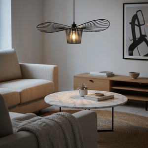 Sensu Infinite Black Pendant Light hanging above a marble coffee table in a cozy living room setting.
