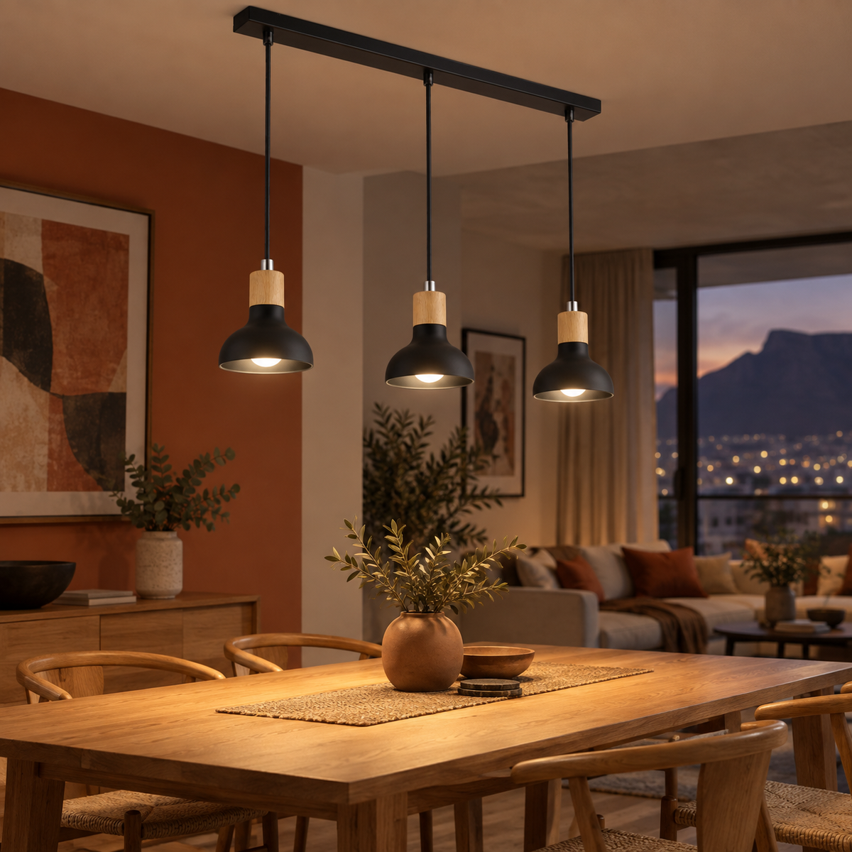 Three-light black pendant over a warm modern dining table